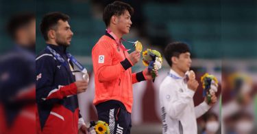 Medal winner athlete allows a 30-second smile for the photo op at the Tokyo Olympics