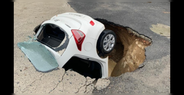 The portion of the road in Dwarka Delhi cave after heavy rain, car jammed