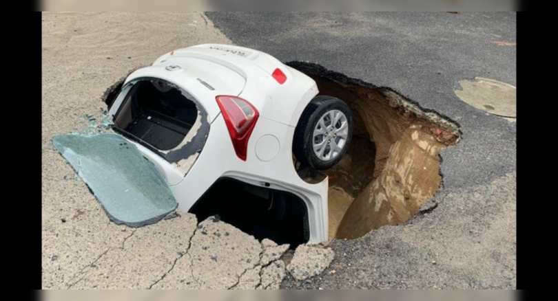 The portion of the road in Dwarka Delhi cave after heavy rain, car jammed