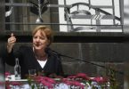 German Chancellor Angela Merkel said the world must rush against climate change; European Flood Toll 188