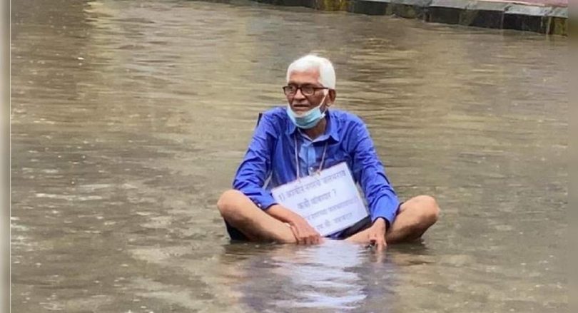 Man sits in the water to protest waterlogging