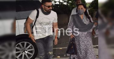 Dharmendra Prakash's wife looks at the airport