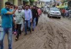 The Minister stopped, taken through Potholed, Muddy Road
